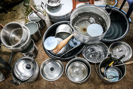 Used pots, dishes, spoons is stain and dirty of food waste wait to cleaning.の写真素材