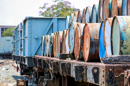 Old chemical tank and oil tank placed on the old train cargo wagon.(Selective focus on the 4th tank)の写真素材