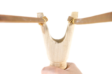 catapult slingshot isolated on white background with kid hand pullingの写真素材