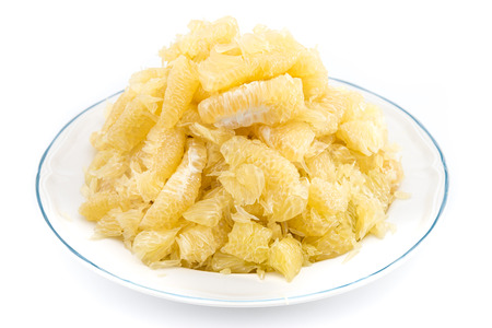 pomelo slices on dish in pyramid shape, isolated white backgroundの写真素材