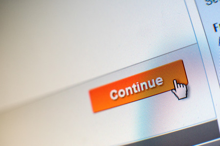 Mouse Clicking \"Continue\" button for internet shopping in an e-commerce websiteの写真素材