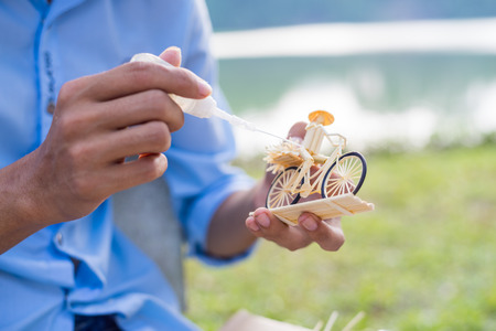 Traditional vietnam crafts using soft wood to make a worker farmer ride on a little bicycleの写真素材