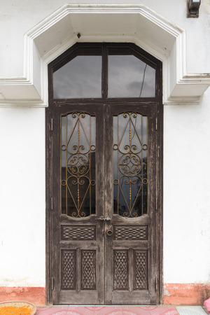 Vintage style doors in front of buildingの写真素材