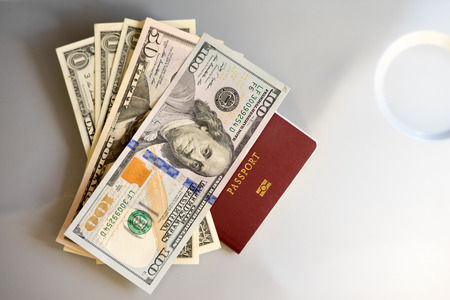 Passport with dollar money staying on table seat have some light from windowの写真素材