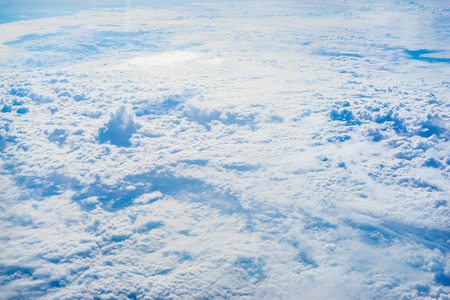 The View from the plane window above the cloud and blue sky