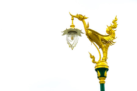 Electric pole with golden thai traditional swan on top isolated on white backgroundの写真素材
