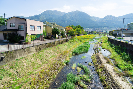 Yufuin, Japan - October 17, 2014: rural home village with mountain and canal landscape viewのeditorial素材