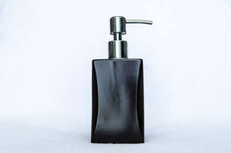 a brown pumping bottle on white backgroundの写真素材