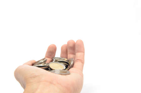 There are many coins in hand, success, begging concept.の写真素材