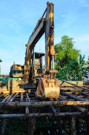 backhoe is building landslide protection near thr canalの写真素材