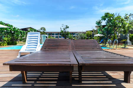 wooden chaise longue at the swimming poolの写真素材