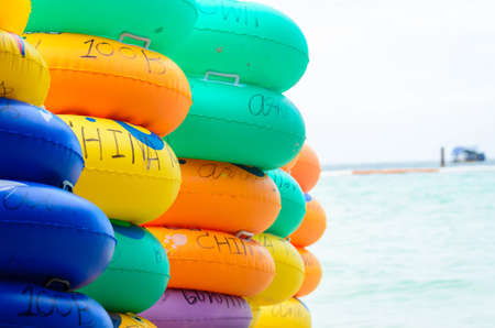 colorful rubber ring on the beachの写真素材