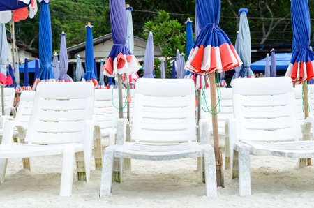 white beach chair and umbrellaの写真素材