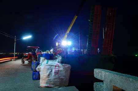 cargo ship and woker in the night timeの写真素材