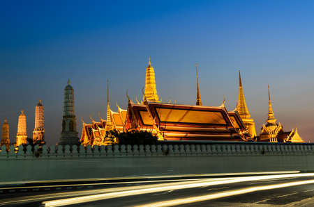 golden palace in the evening with moving car light , Bangkok Thailandのeditorial素材