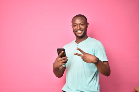 handsome excited young black man feeling excited while viewing content on his smartphone