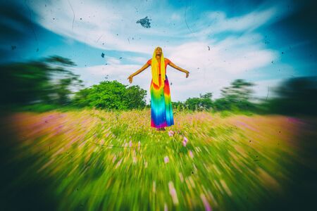 woman levitating outside in a field, alone, surreal, manipulationの写真素材