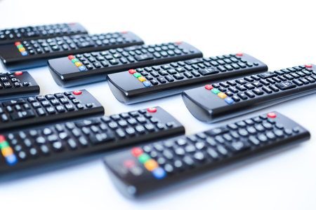 especially heavily blurred black remote controls for the TV on a white background, closeupの写真素材