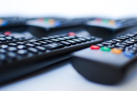 especially heavily blurred black remote controls for the TV on a white background, closeupの写真素材