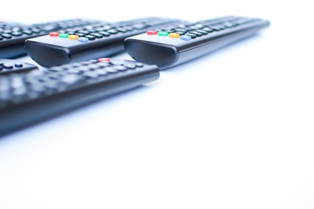 especially heavily blurred black remote controls for the TV on a white background, closeupの写真素材