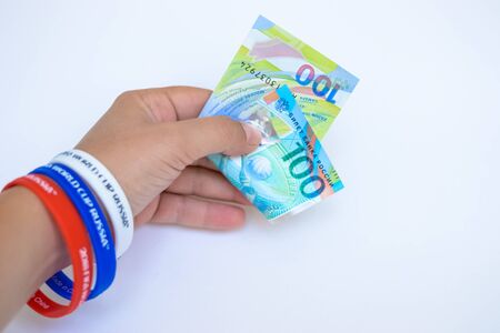 hand holding the newer Russian money issued specifically for the football championship.