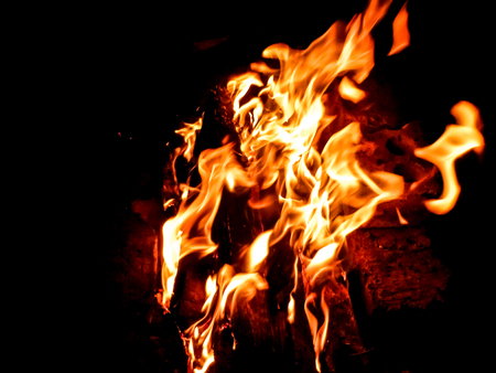orange flame with sparks , a campfire was left after grilling the skewers. burns out in the dark.の写真素材