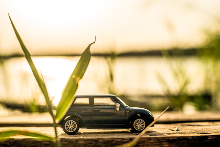blue car on wooden stand on sunset background on the riverの写真素材