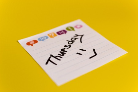 inscription in black marker on Thursday on a white sticker yellow backgroundの写真素材