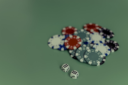 dice and colored casino chips on a black background.の写真素材