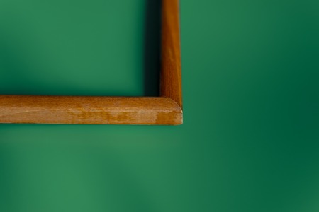green background wooden brown frame. abstraction the angle of the diagonal cut portion.