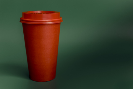 red paper Cup isolated on green background.の写真素材