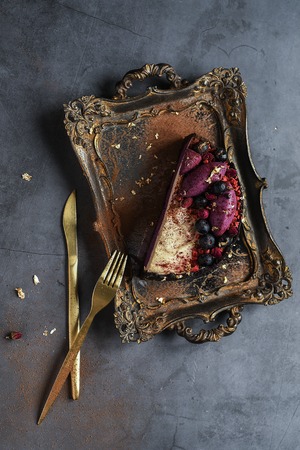 food dessert. chocolate souffle pudding cake filled with fresh berries on the Golden tray with folk and knife.の写真素材