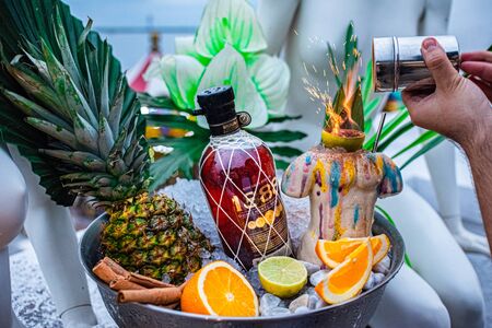 Sochi Russia september 2019 promotional shot of rum bowl with ice pineapple orange hand of the...