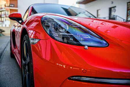 bright red car close up headlight.