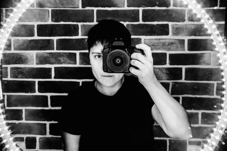 club photographer takes selfie in mirror reflection monochrome led lightsの写真素材