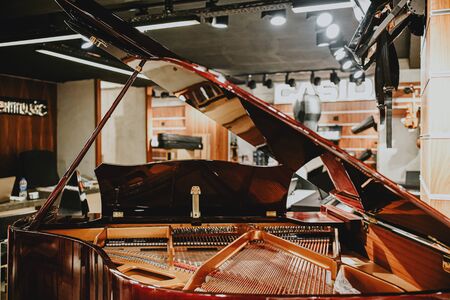open cover of a wooden piano in a music storeのeditorial素材