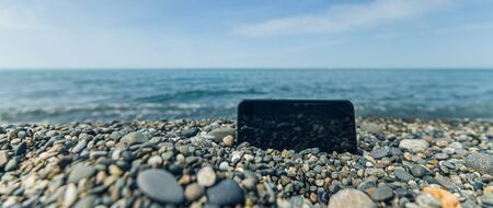 pebbly and rocky beach summer. smartphone freelance coastline of the sea. bannerの写真素材