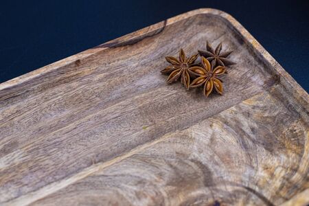anise on a wooden tray . background for cookingの写真素材