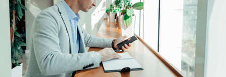 online training a student writes the text of a lecture from their phone to a Notepadの写真素材