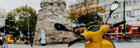 yellow motorbike on the city square as a symbol of travel banner Europe.の写真素材