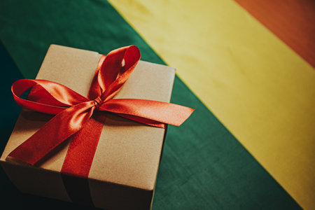 gift box with red bow for christmas on the background of the rainbow flagの写真素材
