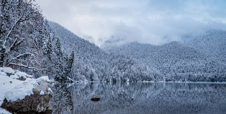 Lake Ritsa winter cloudy weather clouds mirror image of water mountains Abkhazia relict reserveの写真素材