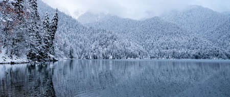 Lake Ritsa winter cloudy weather clouds mirror image of water mountains Abkhazia relict reserveの写真素材