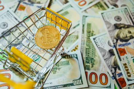 Bitcoin vs Dollars Shopping Cart Background of Hundreds of Dollars Green Yellow