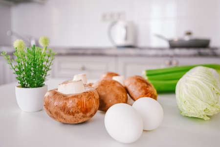 dietary set of products for breakfast. kitchen table mushrooms eggs vegetables