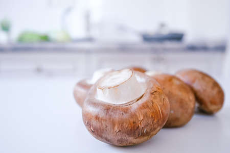 brown mushrooms on a white kitchen table. background copy spaceの写真素材