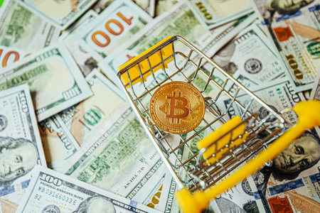 Bitcoin vs Dollars Shopping Cart Background of Hundreds of Dollars Green Yellow.の写真素材