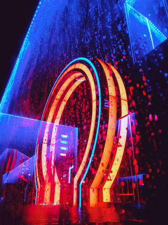 Neon circle line on a dark street background, wet asphalt. raindrop glass. Night view of a street...