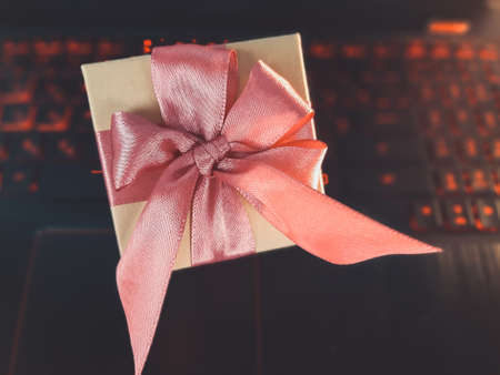gift on laptop computer. valentine's time in office. Online shopping internet banking, store online, business, sale, holidays, vacations, celebration, surprise, ordering a present conceptの写真素材