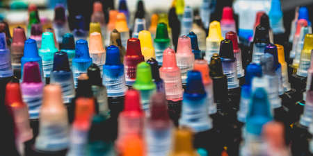 Many bottles with colorful inks for tattoo, close up view.の写真素材